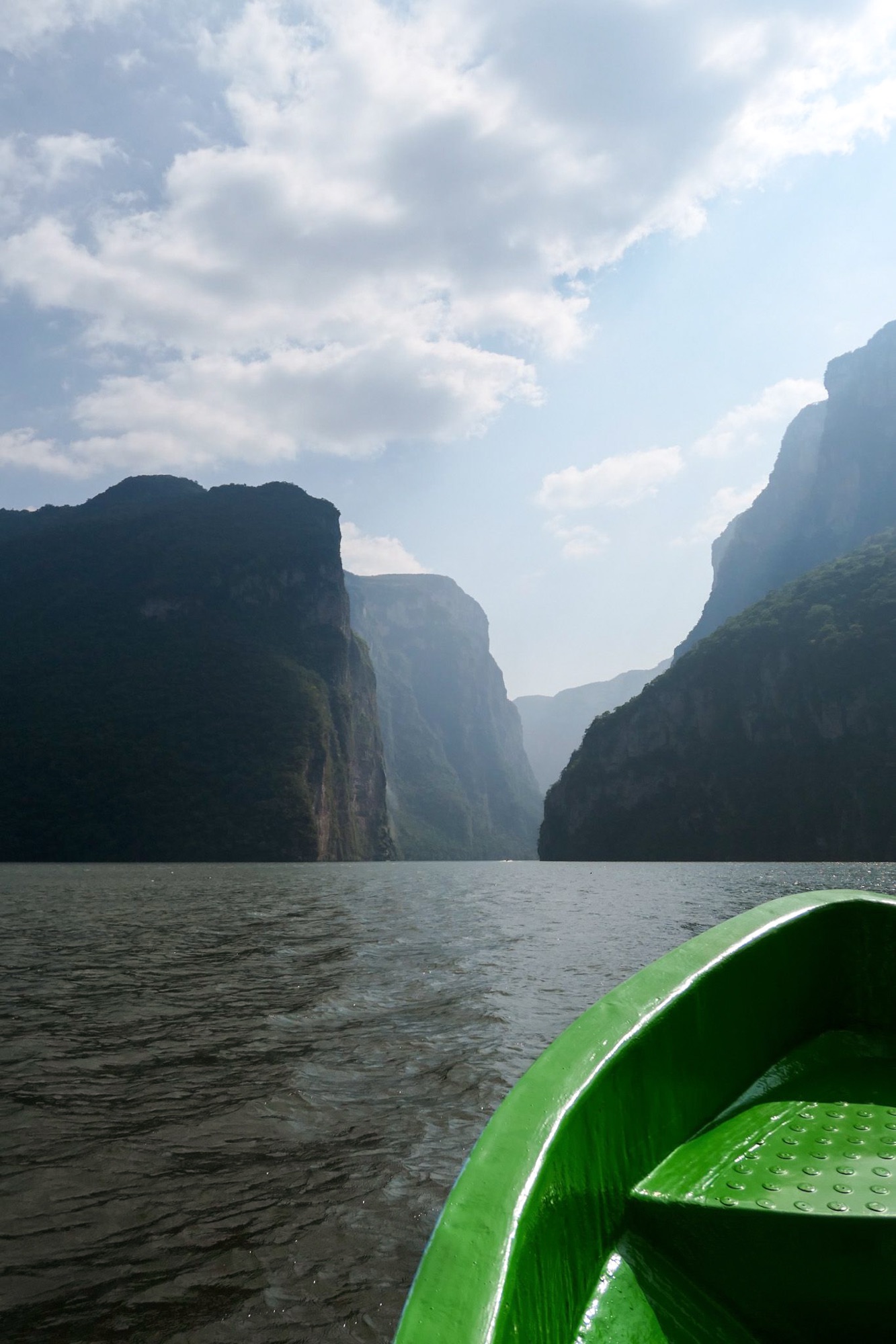View of canyon from water level inside green boat