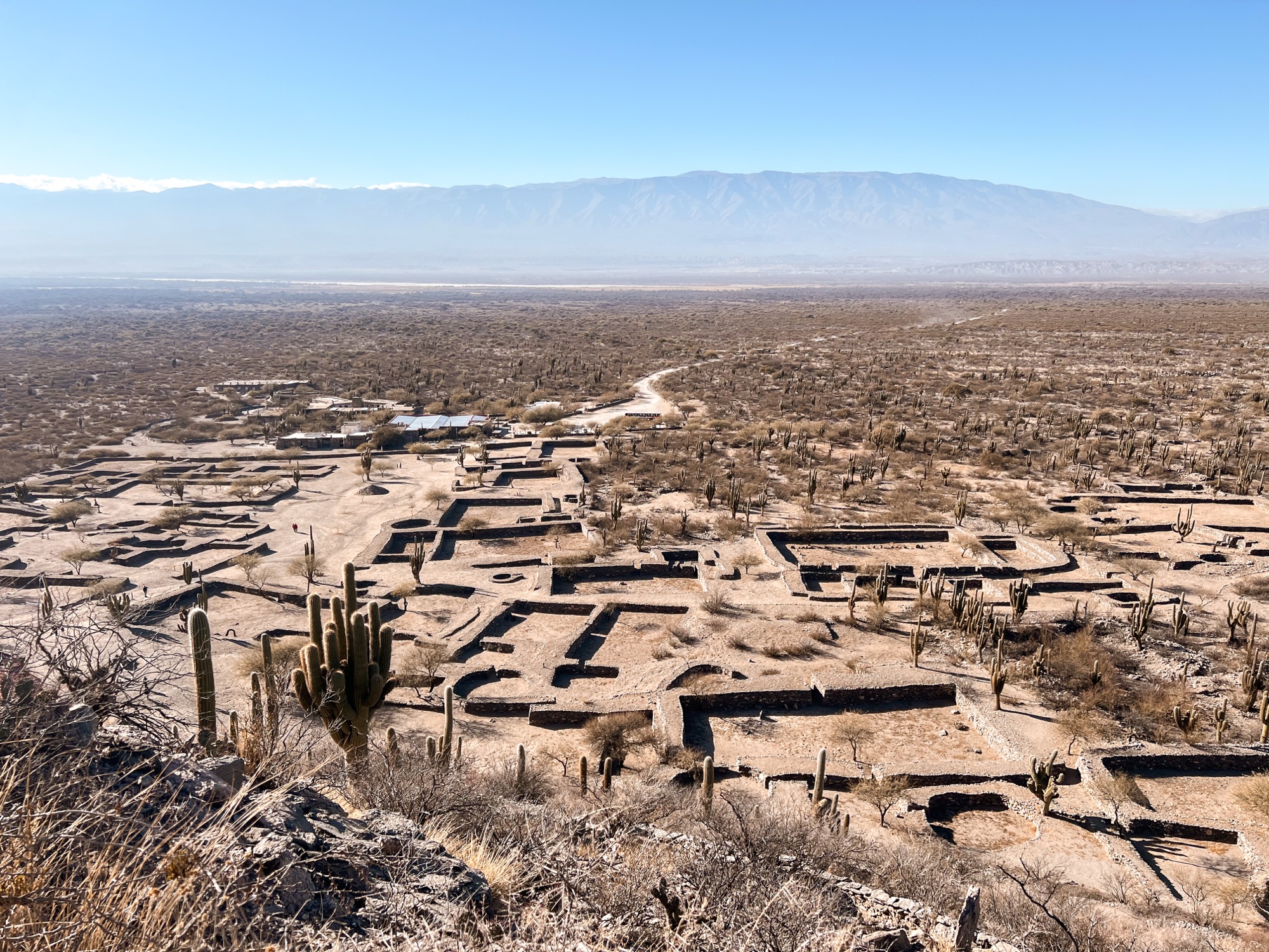 A birds eye view of the ruins of the Sacred City of Quilmes, with the areas mapped out below