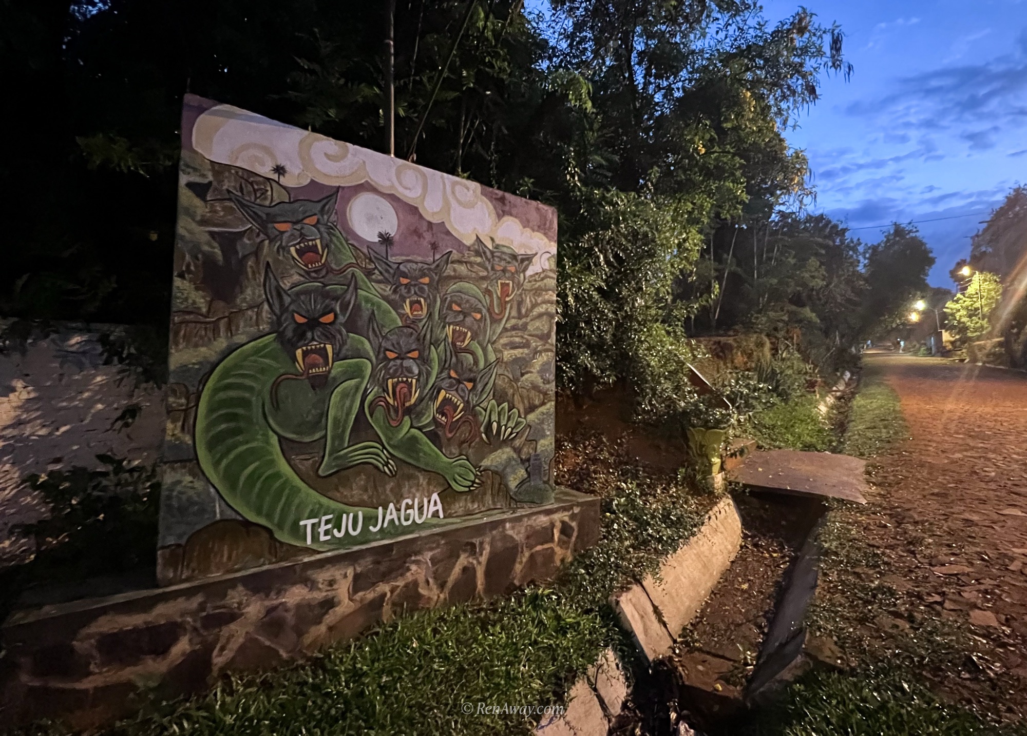 a mural of teju jagua, a guarani monster, is on the left hand side of the myths walk in yaguarón, paraguay
