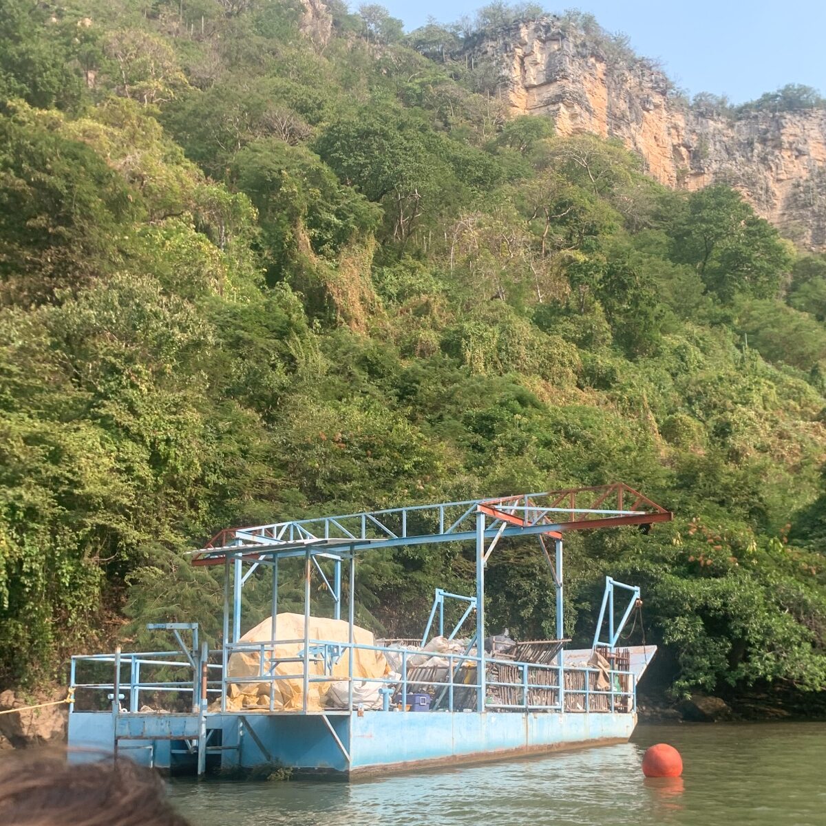 A barge filled with plastic rubbish floating in the sumidero canyon